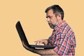 Middle aged stressed man with laptop Royalty Free Stock Photo