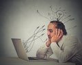 Middle aged tensed man working on computer in his office