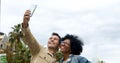 Middle-aged tourist diverse couple taking a selfie in a city. Heterosexual couple on vacation