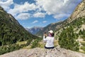 Middle aged tourist woman take a picture from Spanish Pyrenees mountain with mobile phone