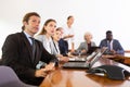 Middle aged white brunette businessman listening to presentation Royalty Free Stock Photo