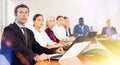 Middle aged white brunette businessman listening to presentation (right side) Royalty Free Stock Photo