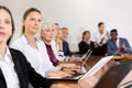 Middle aged white businesswoman sitting at meeting and listening to presentation Royalty Free Stock Photo