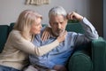 Middle aged wife comforting upset grey-haired husband Royalty Free Stock Photo