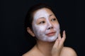 A middle-aged woman Asians are happy with a face mask for skin c Royalty Free Stock Photo