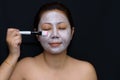 A middle-aged woman Asians are happy with a face mask for skin c Royalty Free Stock Photo