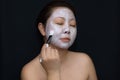 A middle-aged woman Asians are happy with a face mask for skin c Royalty Free Stock Photo