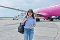 Middle aged woman with backpack, passengers boarding plane background Royalty Free Stock Photo