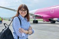 Middle aged woman with backpack, passengers boarding plane background Royalty Free Stock Photo