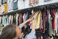 Middle aged woman buys clothes at second hand store Royalty Free Stock Photo