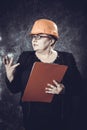 Middle-aged woman construction superintendent in helmet studio portrait. Royalty Free Stock Photo