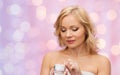 Middle aged woman with cream jar Royalty Free Stock Photo