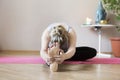 Middle aged woman doing yoga indoors