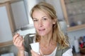 Middle-aged woman eating yoghurt Royalty Free Stock Photo