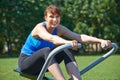 Middle Aged Woman Exercicing On Rowing Machine In Park Royalty Free Stock Photo