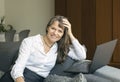 Middle aged woman in formal ware working at home