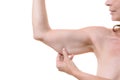 Middle-aged woman grasping her underarm flesh