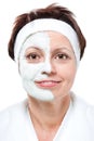 Middle aged woman with half beauty mask