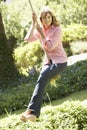 Middle Aged Woman Having Fun On Rope Swing