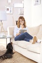 Middle aged woman with her pet dog at home Royalty Free Stock Photo