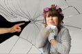 Middle-aged woman, a housewife in curlers, with an unhappy expression on her face rests on the mop with both hands, the male hand Royalty Free Stock Photo