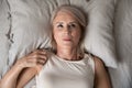 Middle aged woman insomniac lying awake in bed, top view Royalty Free Stock Photo