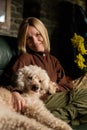 A Middle-aged Woman And A Large Shaggy Dog Are Sitting On A Couch. Relationships, Friendship, Love Of Man And Dog