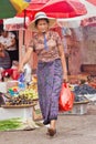 Middle-aged woman leaves a traditional market in Ruili, Yunnan Province, China