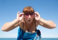 Middle-aged woman looks at camera through tinted sunglasses