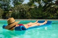 Middle-aged woman lounging lying on a mattress in the water Royalty Free Stock Photo