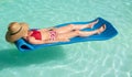 Middle-aged woman lounging lying on a mattress in the water Royalty Free Stock Photo