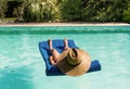 Middle-aged woman lounging lying on a mattress in the water Royalty Free Stock Photo