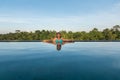 Middle aged woman lounging in a pool.