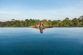 Middle aged woman lounging in a pool.