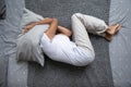 Middle aged woman lying on bed, hiding head under pillow. Royalty Free Stock Photo