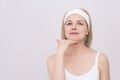 Middle-aged woman makes self-massage of the face, exercise to get rid double chin Royalty Free Stock Photo