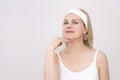Middle-aged woman makes self-massage of the face, exercise to get rid double chin Royalty Free Stock Photo