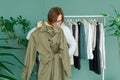 Middle aged woman shopping new dress clothes shelf green Royalty Free Stock Photo