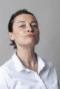 Middle aged woman with mole posing with chin up for arrogance