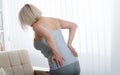 Middle aged woman with pain in the backache and lower back. Concept photo with indicating location of the pain. Health Royalty Free Stock Photo