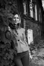 A middle-aged woman in a park near an ancient house. Black and white photo. Royalty Free Stock Photo