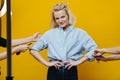 Middle aged woman posing for a photo while hands correting her clothes