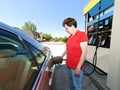 Middle Aged Woman Pumping Gas At Station Royalty Free Stock Photo