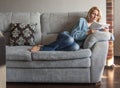 Woman reading a book on the couch Royalty Free Stock Photo