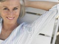 Middle Aged Woman Reclining On Sunlounger Royalty Free Stock Photo