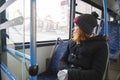 A middle-aged woman with red hair sits on a seat while riding a bus Royalty Free Stock Photo