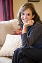 Middle-aged woman relaxing on living room sofa Royalty Free Stock Photo