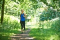 Middle Aged Woman Running In Countryside