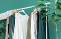 Middle aged woman shopping new dress clothes shelf green Royalty Free Stock Photo