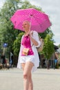 middle-aged woman with a short haircut with an umbrella protecting from sun Royalty Free Stock Photo